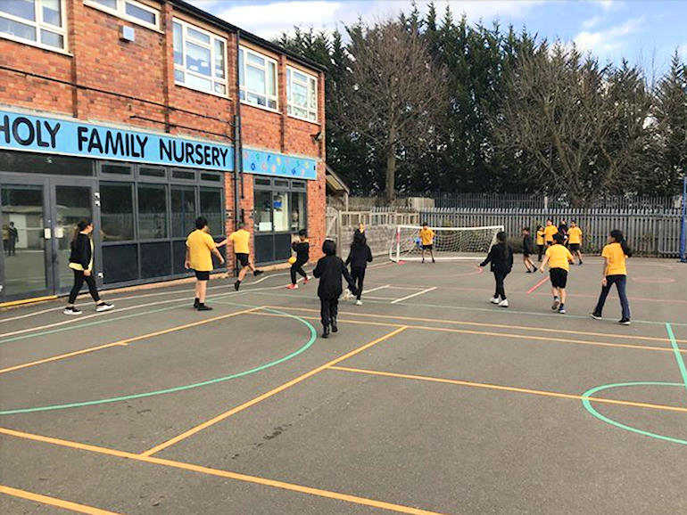 Children playing football on the playing field