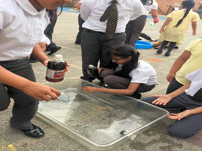 Children enjoying scientific experiments in the playground
